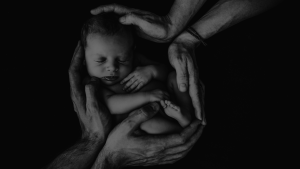 image of couple holding new born in arms